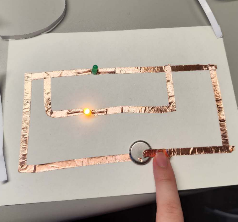 This is me trying to connect a series circuit. I've got one of the bulbs' electrodes installed in the wrong direction. I'm testing it.
