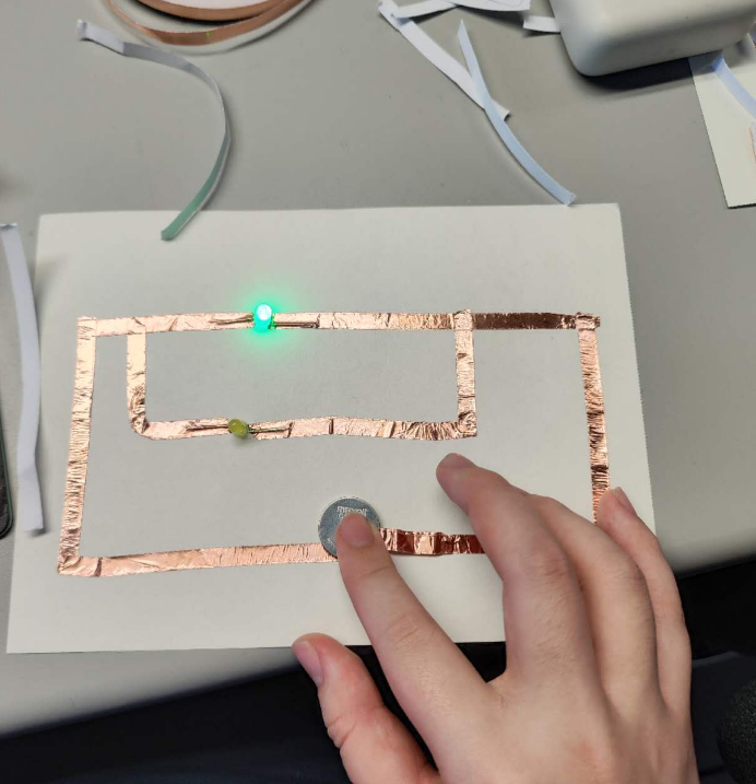 This is me trying to connect a series circuit. I've got one of the bulbs' electrodes installed in the wrong direction. I'm testing it.