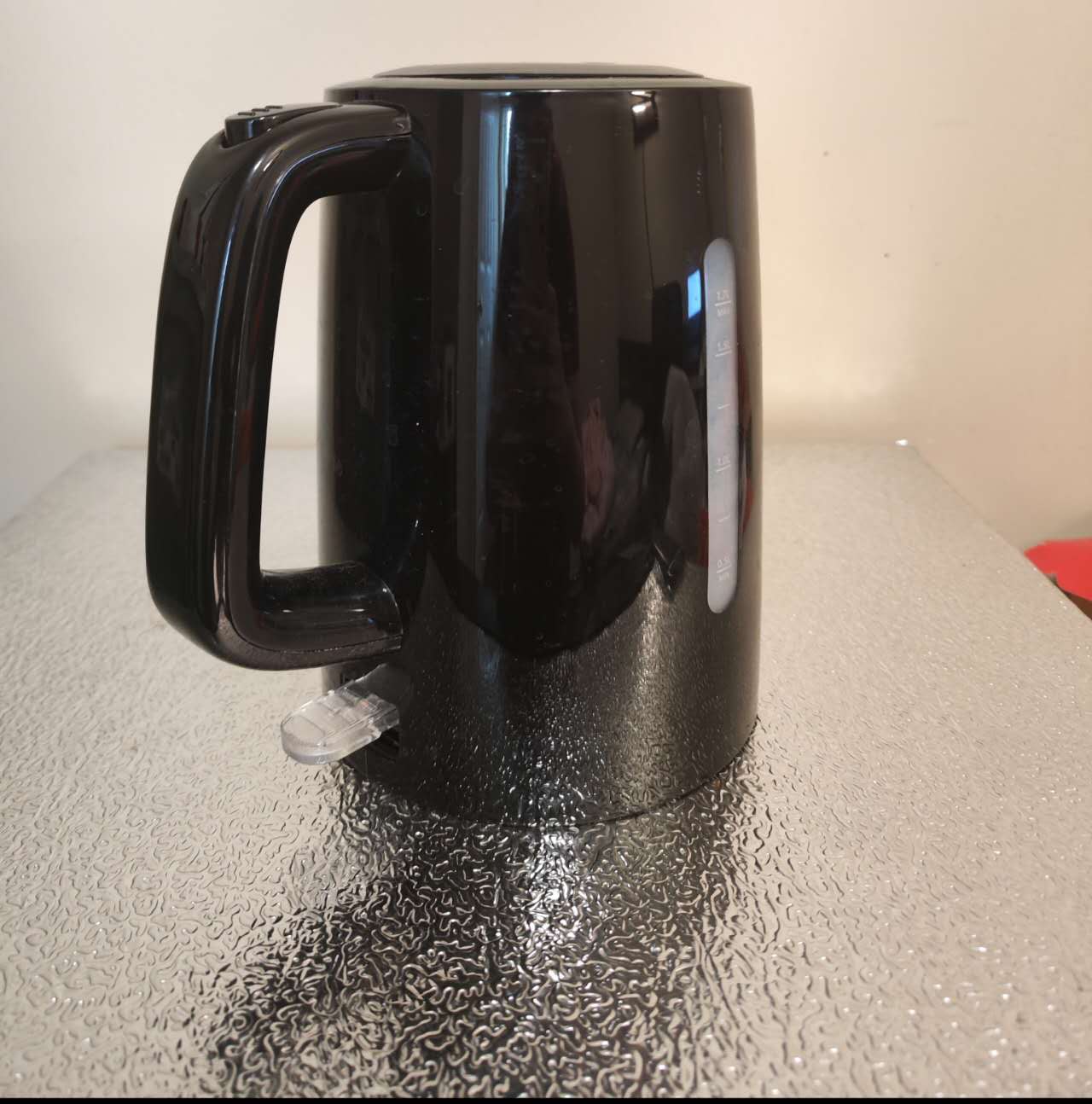 This is my electric kettle from another angle. It has a spout, a handle, and a lid. It is a complex geometry.